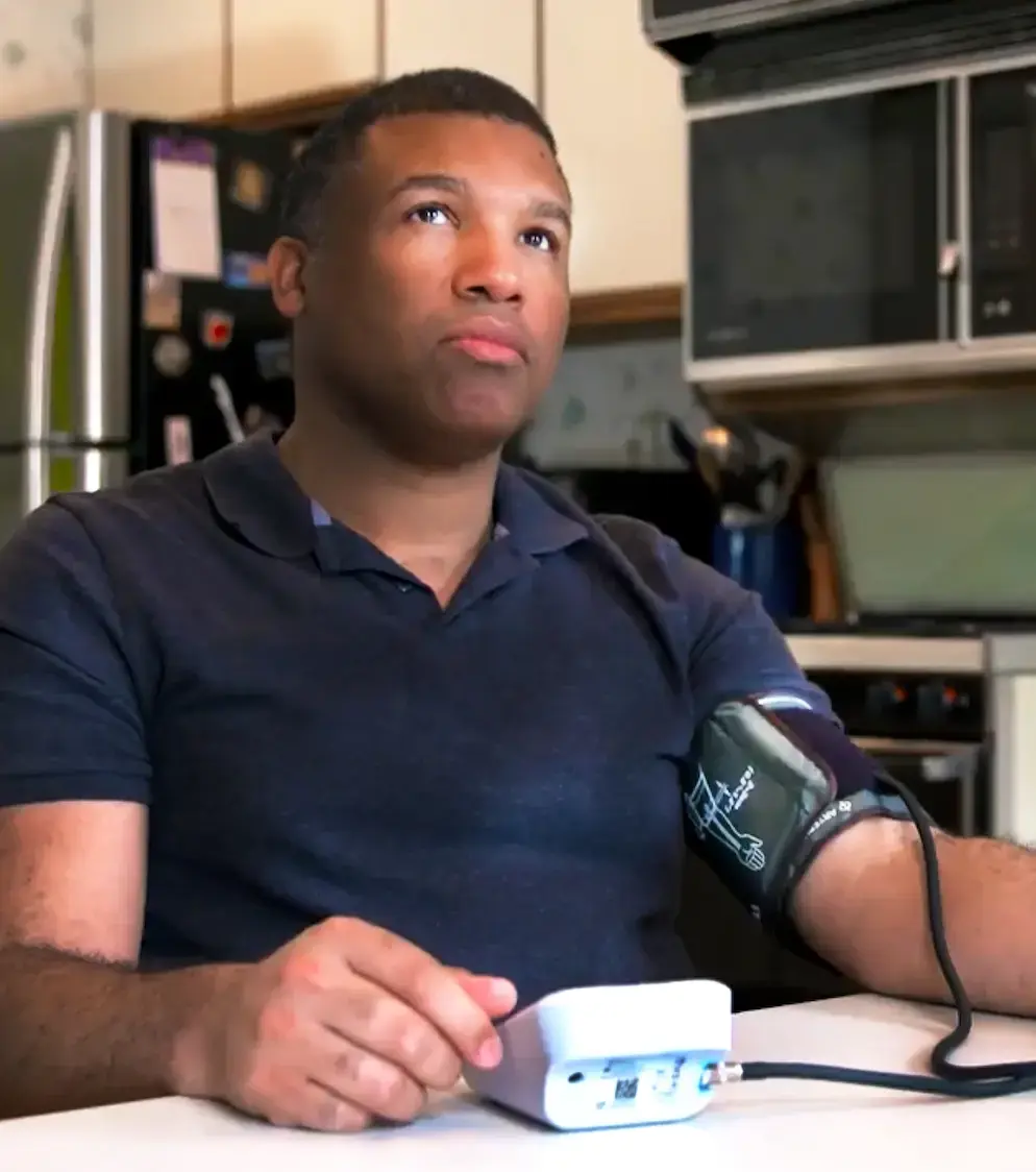 A man checking his blood pressure at home