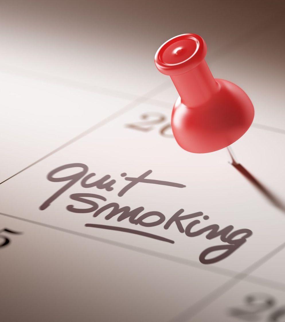 A man contemplates quitting smoking while watching his children