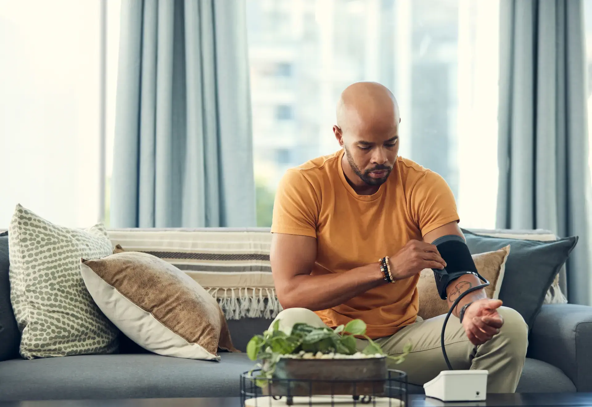 Man checking his own blood pressure in his home