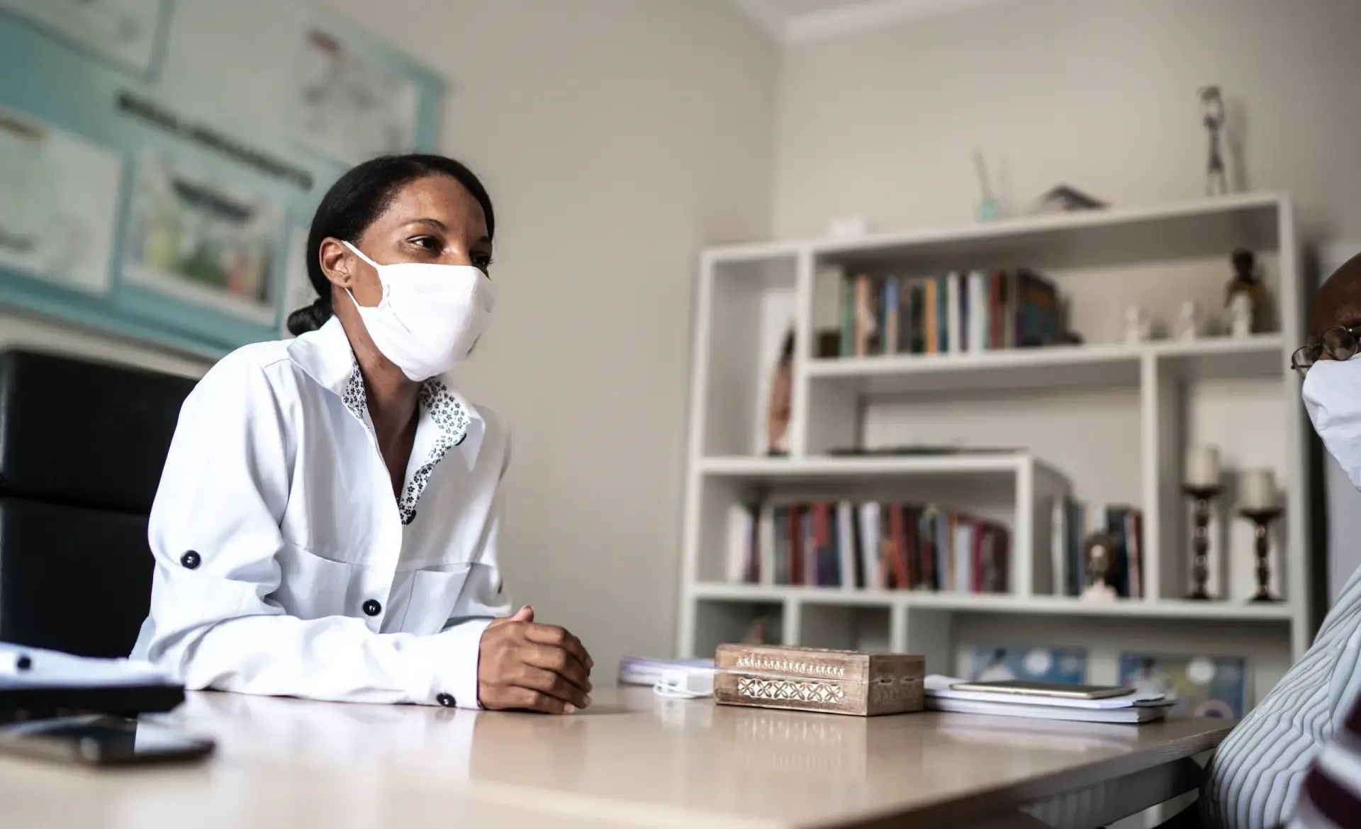 Woman sitting at a desk talking to a man