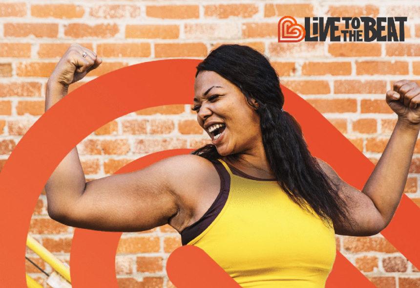 Woman smiling and showing her muscles